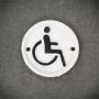 tabliczka żeliwna emblemat wózek inwalidzki